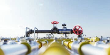 A group of pipes and valves in a field, showcasing the impact of increased U.S. natural gas exports on CO2 emissions.