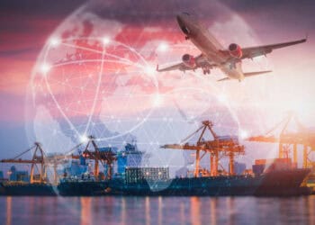 Global supply chain: cargo ship at port with airplane overhead, illustrating international trade and logistics challenges. - Supply Chain News