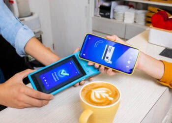 Person using smartphone for contactless payment via a card reader. Payment accepted. - Supply Chain News