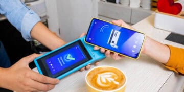 Person using smartphone for contactless payment via a card reader. Payment accepted. - Supply Chain News