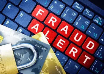Credit cards, padlock, and keyboard displaying "FRAUD ALERT". Beware of delayed disconnect scams targeting Canadian bank customers. - Supply Chain News