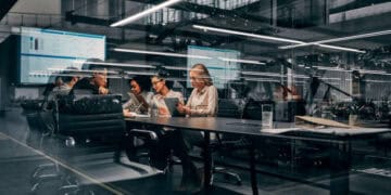 A group of people, including KeyCorp's Chief Risk Officer, Darrin Benhart, sitting around a table in an office.