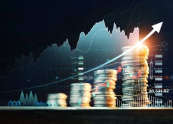 Stacks of coins rising with upward trending graph, illustrating economic growth despite pandemic challenges in China. - Supply Chain News
