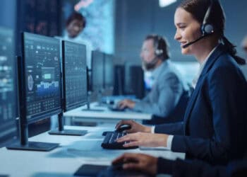 Businesspeople in a call center working at computers. - Supply Chain News