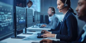 Businesspeople in a call center working at computers. - Supply Chain News