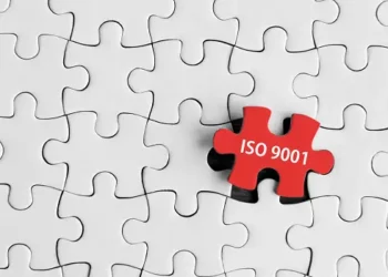 Red puzzle piece with "ISO 9001" fits into a larger white puzzle. - Supply Chain News