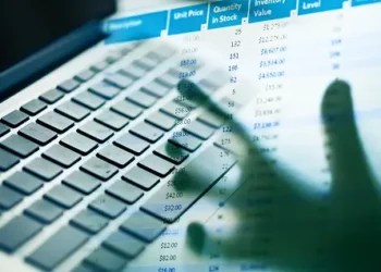 Hands typing on laptop keyboard, MyGov and ATO account data visible on screen. Australian tax fraud. - Supply Chain News