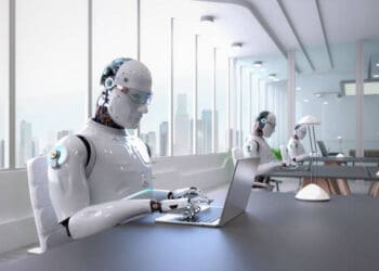 Robots working on laptops in modern office. AI technology. - Supply Chain News