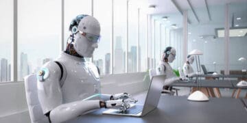 Robots working on laptops in modern office. AI technology. - Supply Chain News