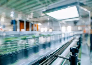 A blurry image of a conveyor belt in a factory undergoing Rapid Transformation.