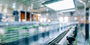 A blurry image of a conveyor belt in a factory undergoing Rapid Transformation.