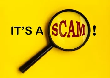 Magnifying glass revealing "SCAM!" warning against online financial scams promising quick returns. - Supply Chain News