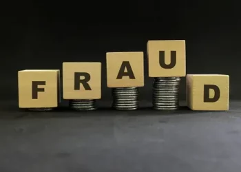Wooden blocks spelling "FRAUD" stacked on coins; telehealth fraud concerns. - Supply Chain News