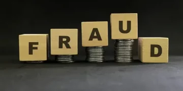 Wooden blocks spelling "FRAUD" stacked on coins; telehealth fraud concerns. - Supply Chain News