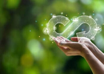 A woman's hand holding an infinity symbol on a green background, representing growth prospects in Djibouti.