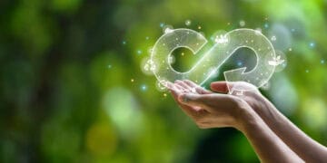 A woman's hand holding an infinity symbol on a green background, representing growth prospects in Djibouti.
