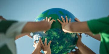 A group of people holding a globe representing global cooperation in Africa.