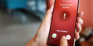 Smartphone displaying "Suspected Spam" warning, illustrating the fight against economic crime in UK financial services using AI. - Supply Chain News