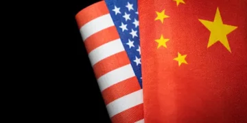 Two american and chinese flags on a black background signifying the importance of US-China Economic Relations.