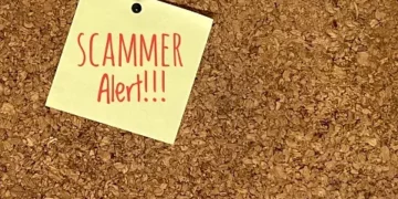 Sticky note on corkboard: Scammer Alert!! Rising Australian scams. - Supply Chain News