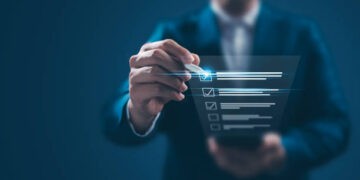 Businessperson checking items on a digital checklist. - Supply Chain News