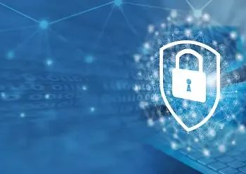 A person is using a laptop while being cautious of online threats.