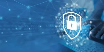 A person is using a laptop while being cautious of online threats.