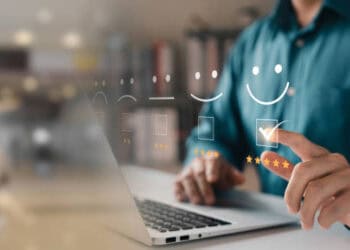 Person using laptop, reviewing positive customer feedback and performance metrics. - Supply Chain News