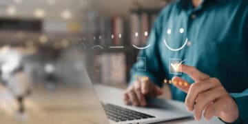 Person using laptop, reviewing positive customer feedback and performance metrics. - Supply Chain News