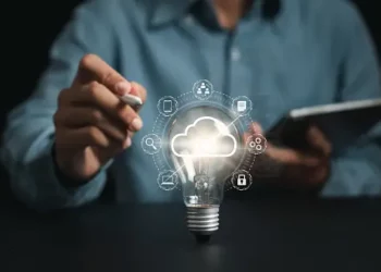 A man is holding a AI-Powered light bulb.