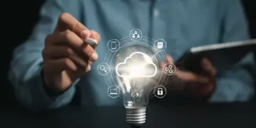 A man is holding a AI-Powered light bulb.