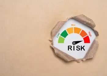 A risk gauge on a piece of paper measuring Thailand's economic recovery measures.