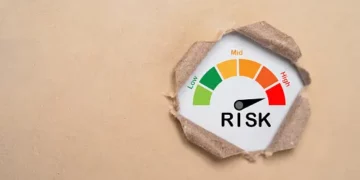 A risk gauge on a piece of paper measuring Thailand's economic recovery measures.