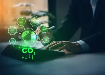 Person using tablet to monitor CO2 reduction via ethical biotrade practices. - Supply Chain News