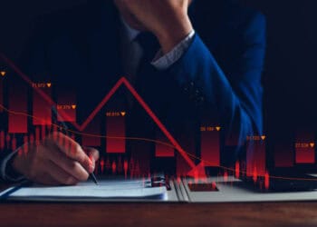 Businessman reviewing financial documents showing a sharp market downturn. Cryptocurrency, prison sentence. - Supply Chain News