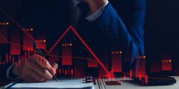 Businessman reviewing financial documents showing a sharp market downturn. Cryptocurrency, prison sentence. - Supply Chain News