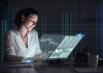 Woman reviewing financial data on a futuristic laptop. Taiwan crypto bill. - Supply Chain News