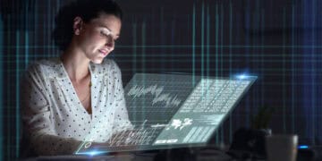 Woman reviewing financial data on a futuristic laptop. Taiwan crypto bill. - Supply Chain News