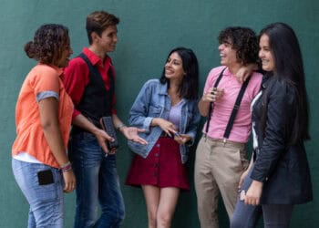 Group of young adults talking and laughing together. - Supply Chain News