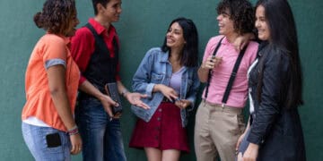 Group of young adults talking and laughing together. - Supply Chain News