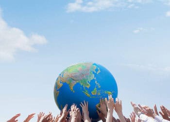 A group of people from Russia and Africa holding a globe in their hands, symbolizing cooperation.