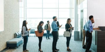 People waiting in line at a bank. - Supply Chain News