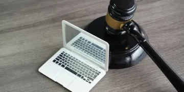 Gavel and laptop; Brazil's first data protection law penalty. - Supply Chain News