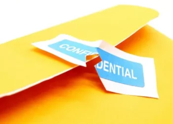 Torn confidential label on a yellow folder; data breach - Supply Chain News