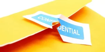 Torn confidential label on a yellow folder; data breach - Supply Chain News