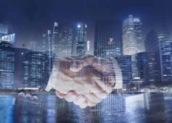 Two business people shaking hands in front of a city during the G20 Summit.