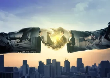 The US Commerce Secretary conducts a China Visit to discuss Economic Issues with business people, shaking hands in front of a city.