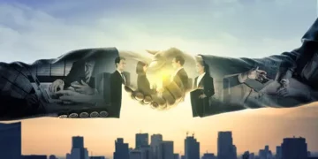 The US Commerce Secretary conducts a China Visit to discuss Economic Issues with business people, shaking hands in front of a city.