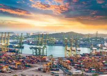 An aerial view of a container port at sunset highlighting the smooth operation of supply chains.