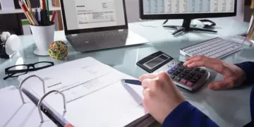 A person using software bills of materials to enhance cybersecurity at a desk.